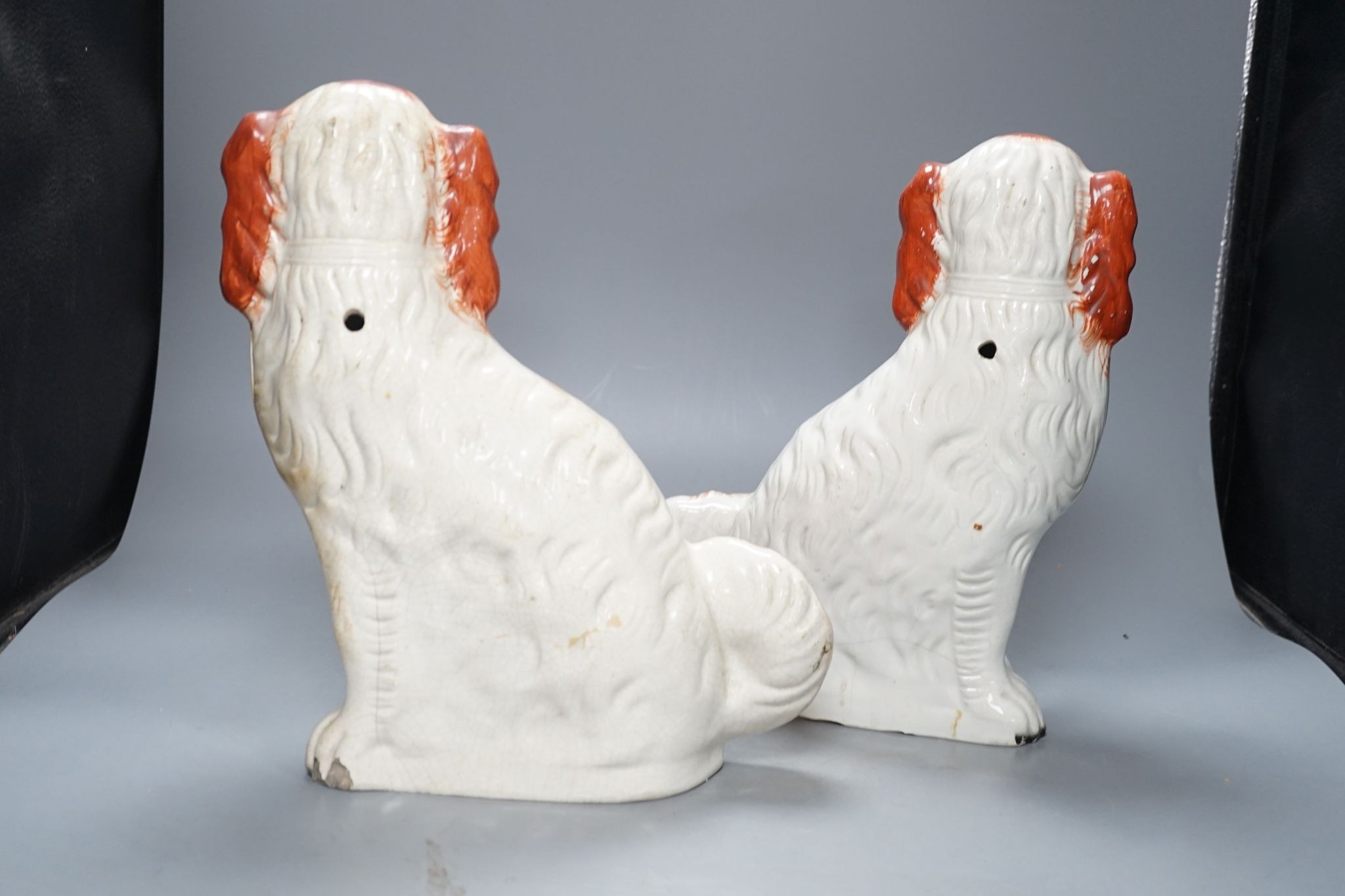 A pair of Victorian Staffordshire Spaniel chimney dogs and a greyhound, chimney dogs 31 cms high.